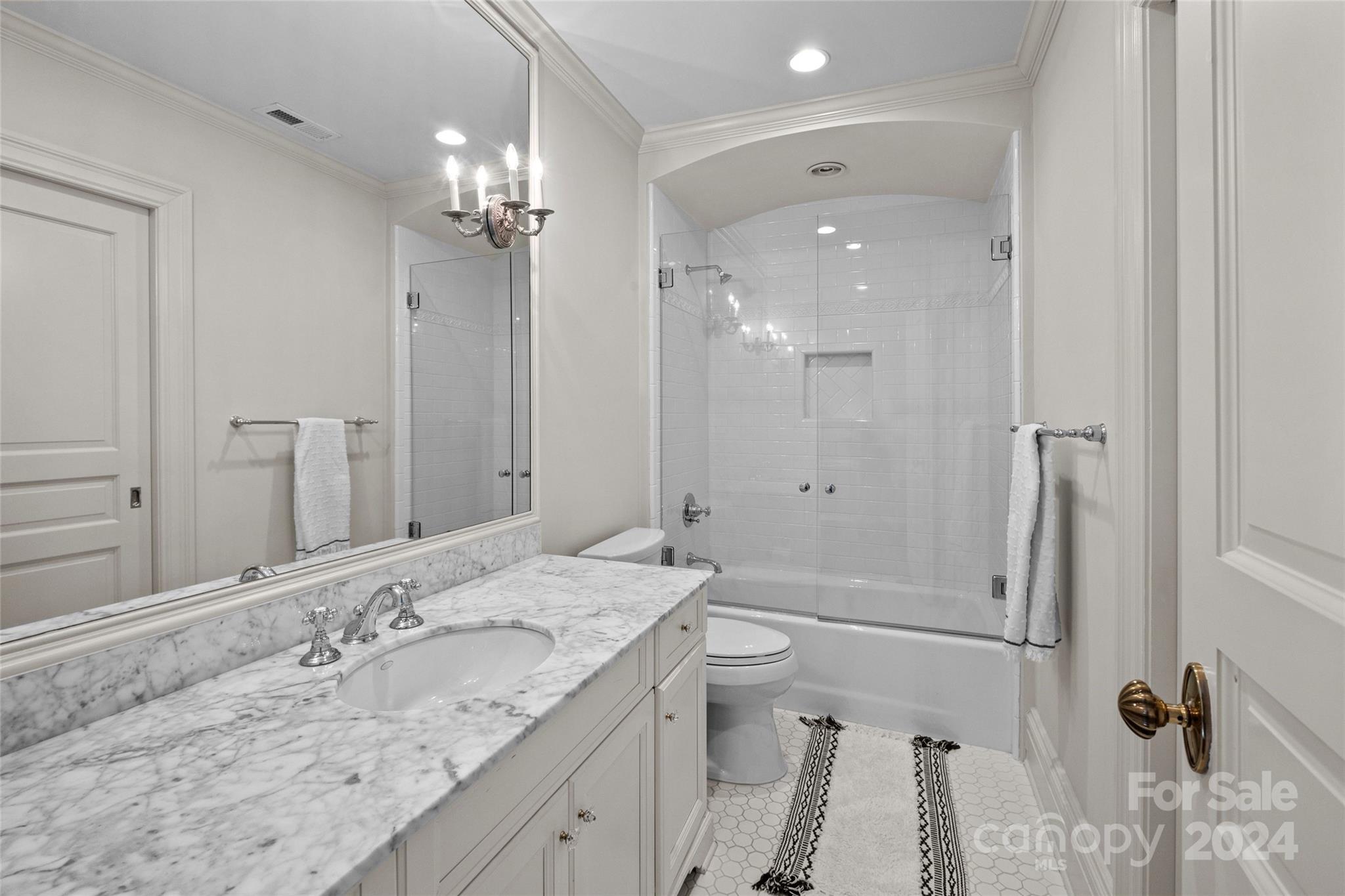 1930 Queens Road West Charlotte, NC 28209 - Photo 24 of 47 a bathroom with a granite countertop sink a toilet a shower and a mirror