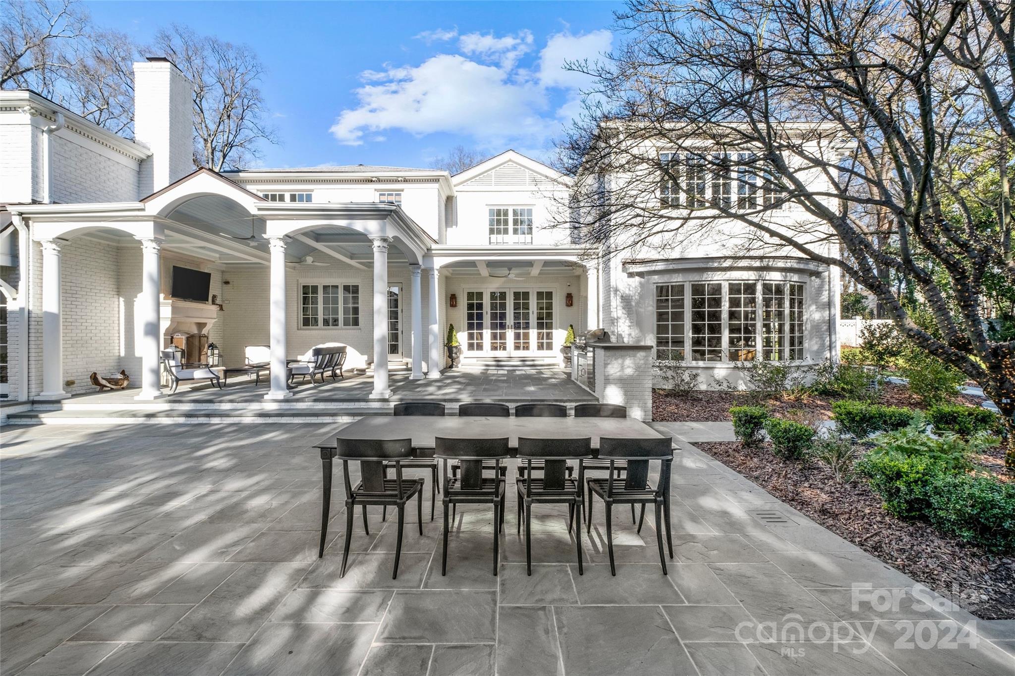 1930 Queens Road West Charlotte, NC 28209 - Photo 27 of 47 a view of a brick house with a chairs and table in a patio