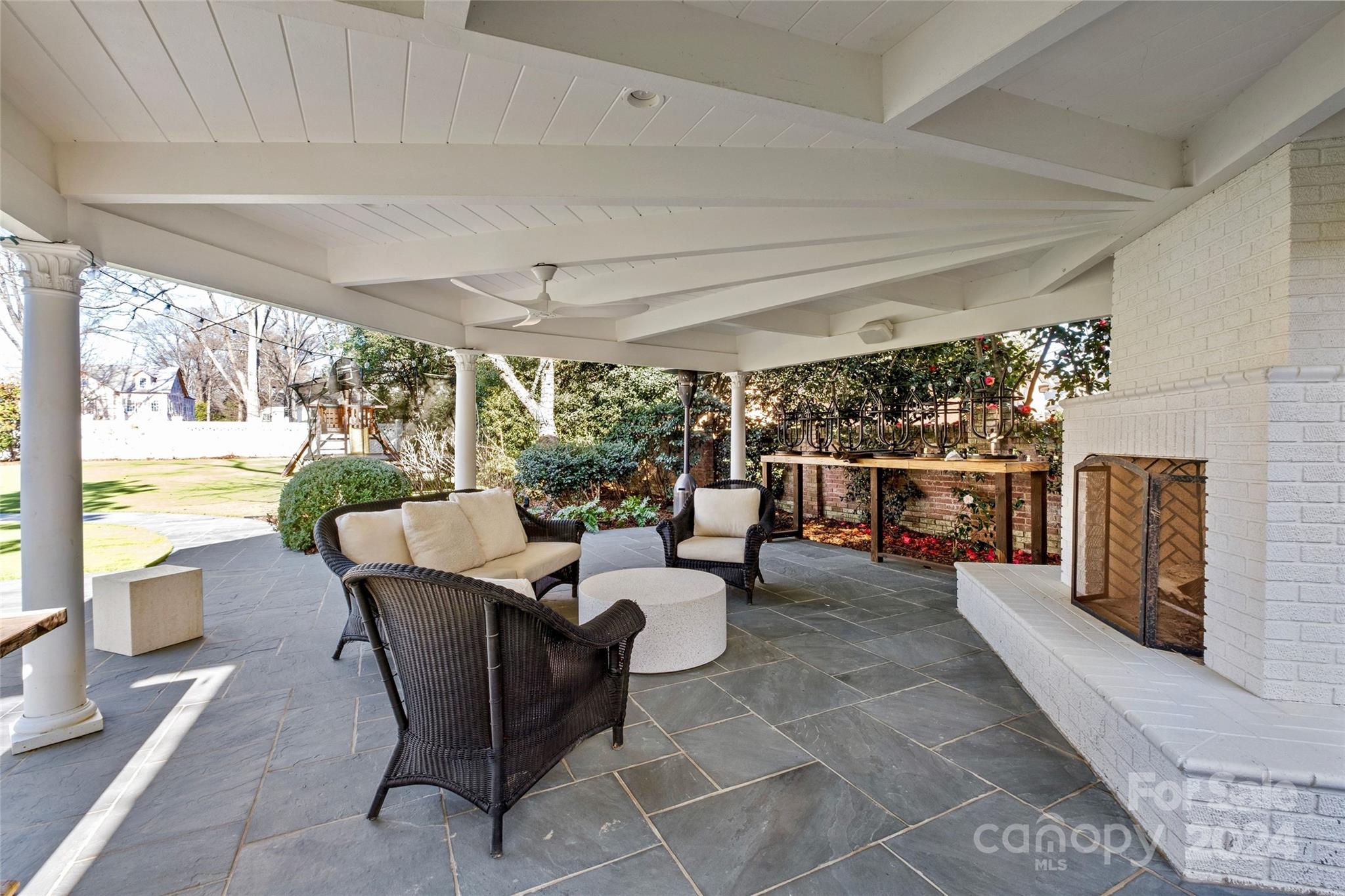 1930 Queens Road West Charlotte, NC 28209 - Photo 34 of 47 a living room with patio furniture and a fireplace