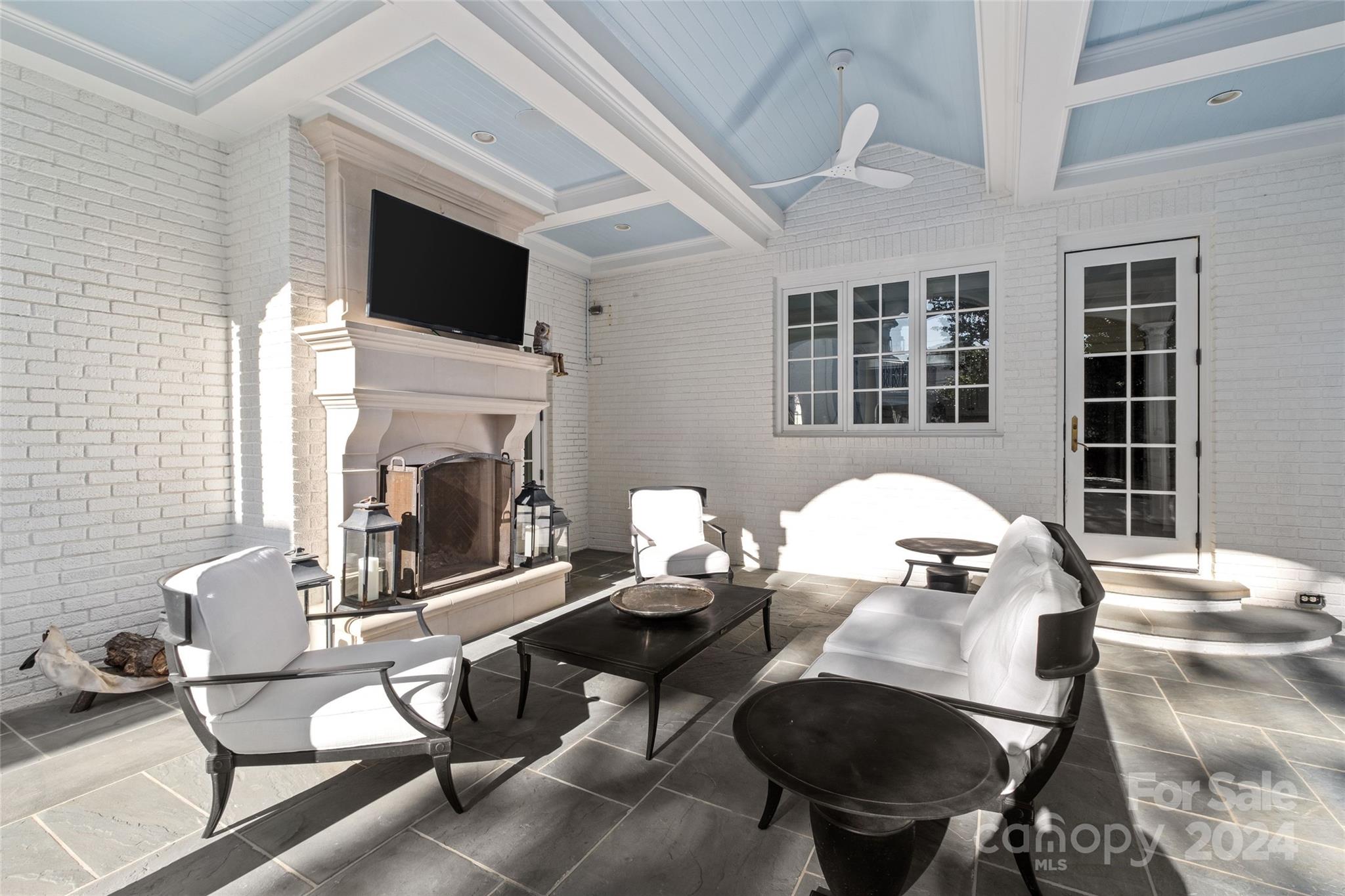 1930 Queens Road West Charlotte, NC 28209 - Photo 35 of 47 a living room with furniture a fireplace and a flat screen tv