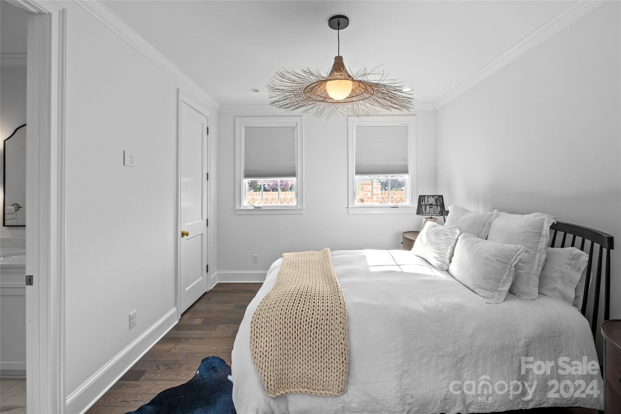 1930 Queens Road West Charlotte, NC 28209 - Photo 42 of 47 a bedroom with a bed and a chandelier