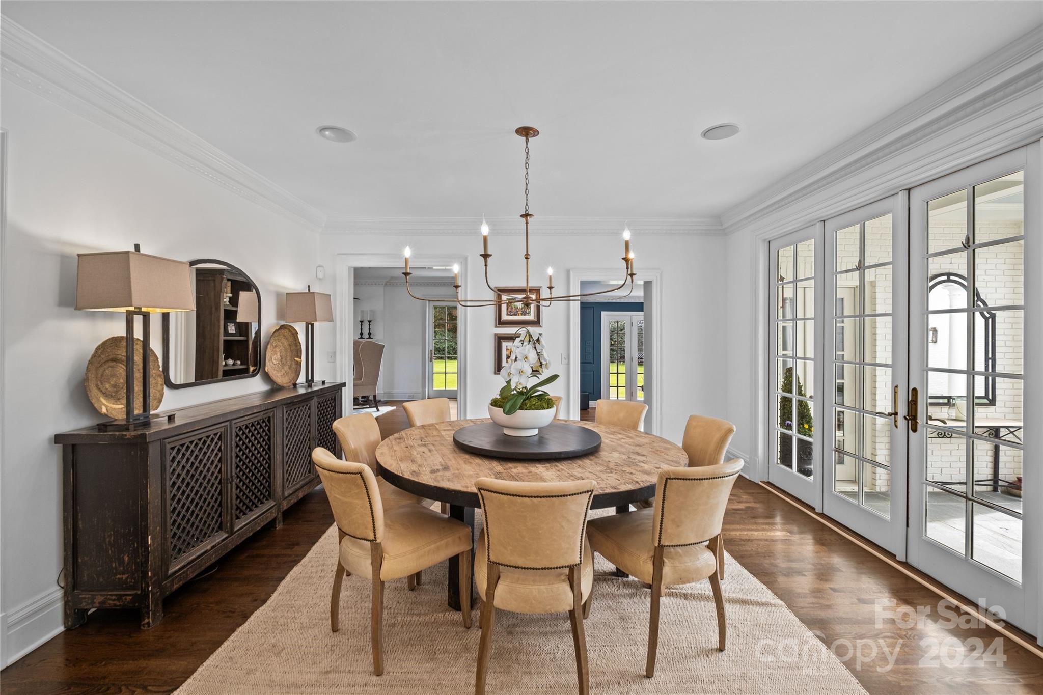 1930 Queens Road West Charlotte, NC 28209 - Photo 8 of 47 a dining room with furniture a chandelier and wooden floor