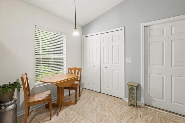 a kitchen with stainless steel appliances granite countertop white cabinets and a stove top oven