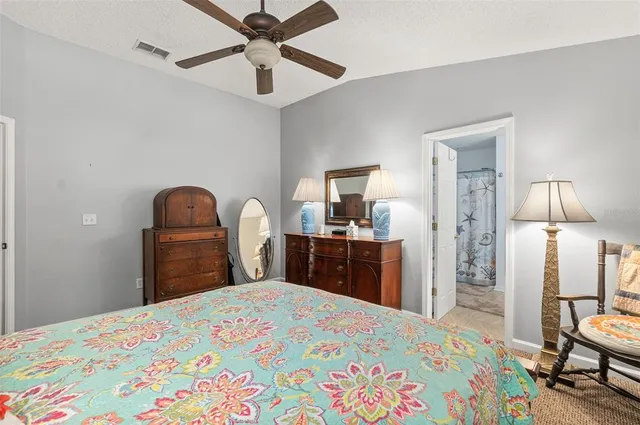 a bathroom with a granite countertop sink a toilet a mirror a vanity and shower