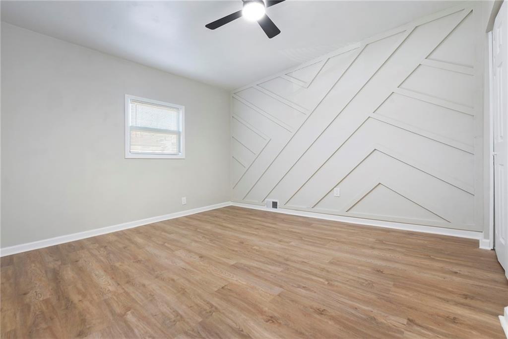 440 Ruxton Street Pittsburgh, PA 15211 - Photo 15 of 37 an empty room with wooden floor chandelier fan and windows