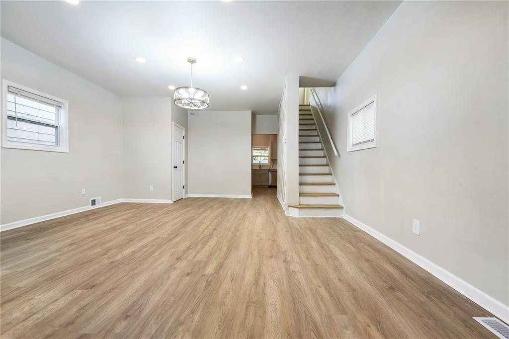 440 Ruxton Street Pittsburgh, PA 15211 - Photo 35 of 37 an empty room with wooden floor and stairs