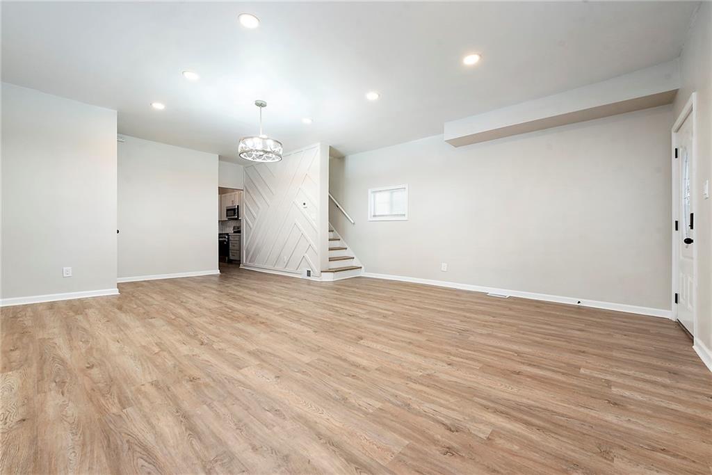 440 Ruxton Street Pittsburgh, PA 15211 - Photo 5 of 37 an empty room with wooden floor and windows