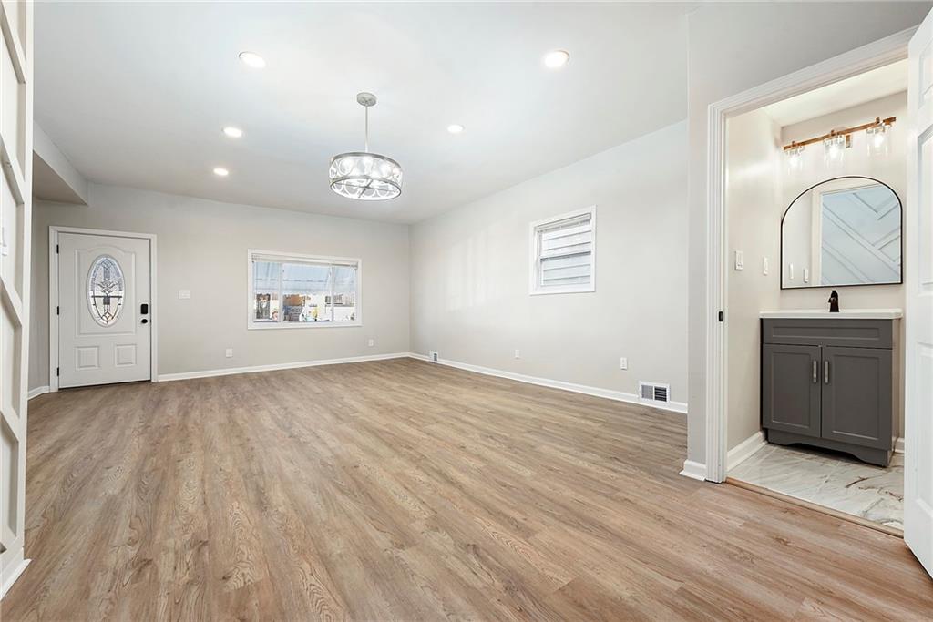 440 Ruxton Street Pittsburgh, PA 15211 - Photo 7 of 37 an empty room with wooden floor cabinet and windows