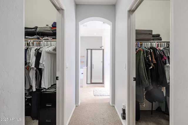 a view of walk in closet with clothes