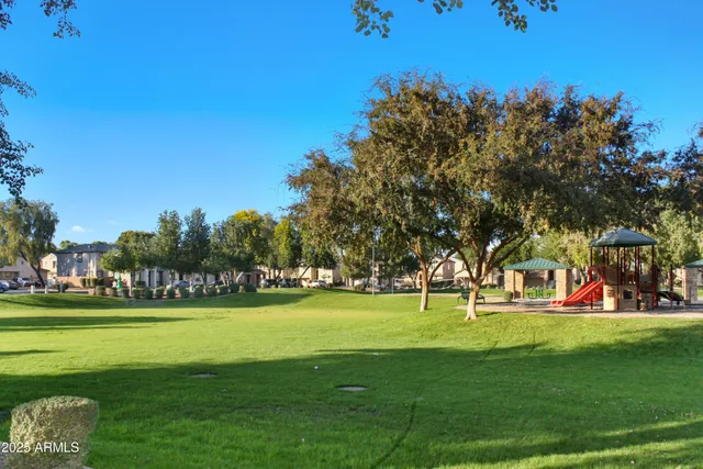 a front view of a house with yard and green space