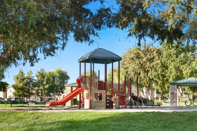 a view of a white house with a large windows and a small yard