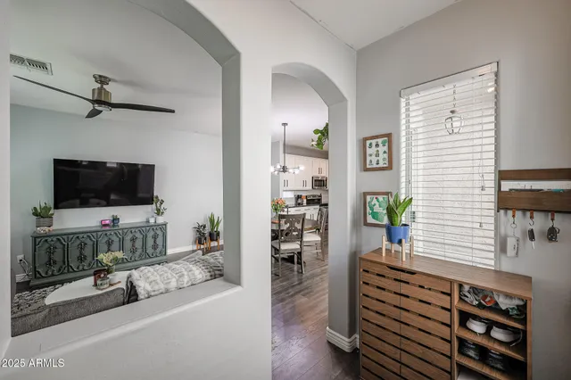 a living room with furniture and a potted plant