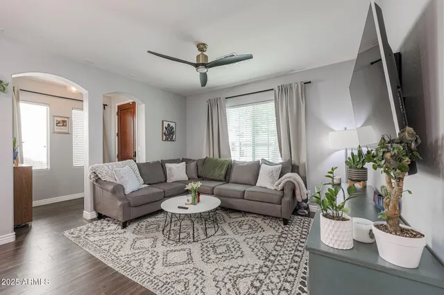 a living room with furniture kitchen and a table