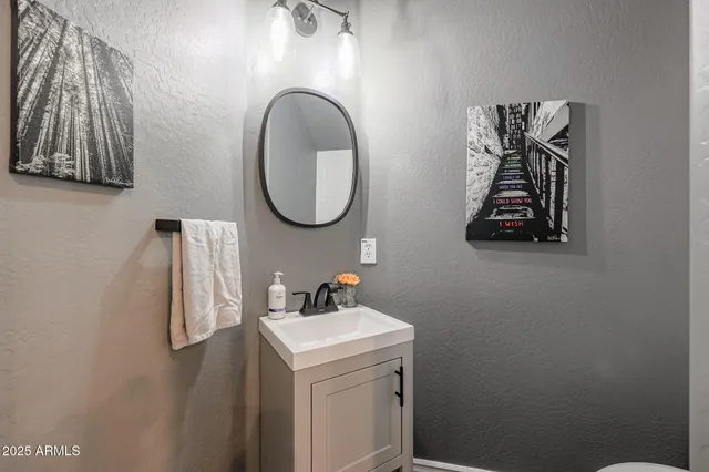 a kitchen with stainless steel appliances a refrigerator a stove top oven and wooden floor