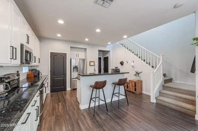 a kitchen with stove a sink and cabinets