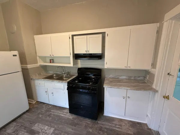 a kitchen with a stove and a refrigerator