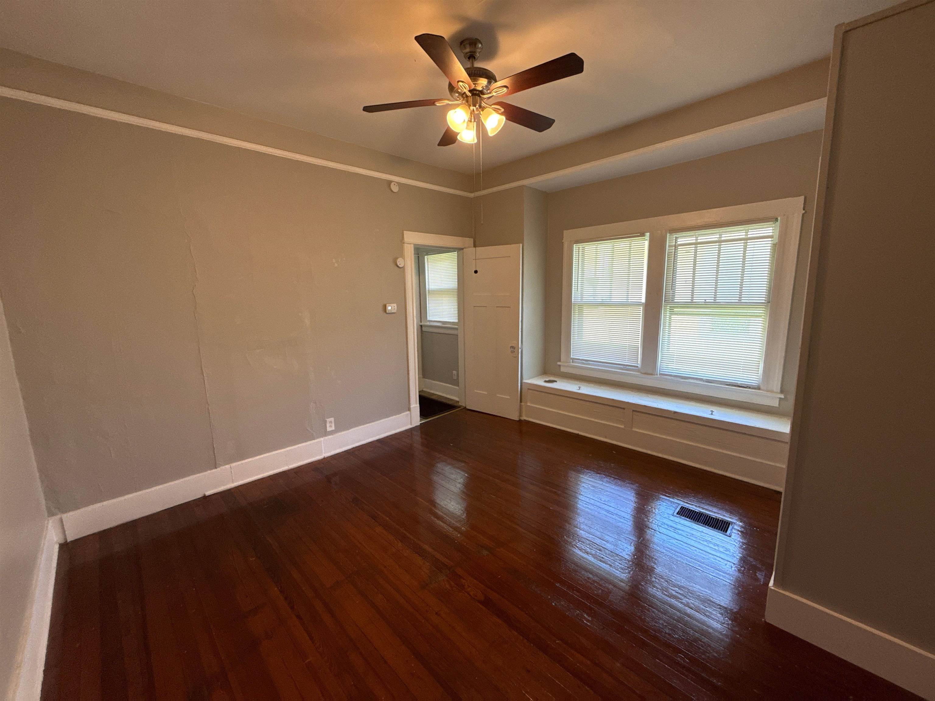 1053 Fleece Place Memphis, TN 38104 - Photo 3 of 14 a view of an empty room with wooden floor and a window