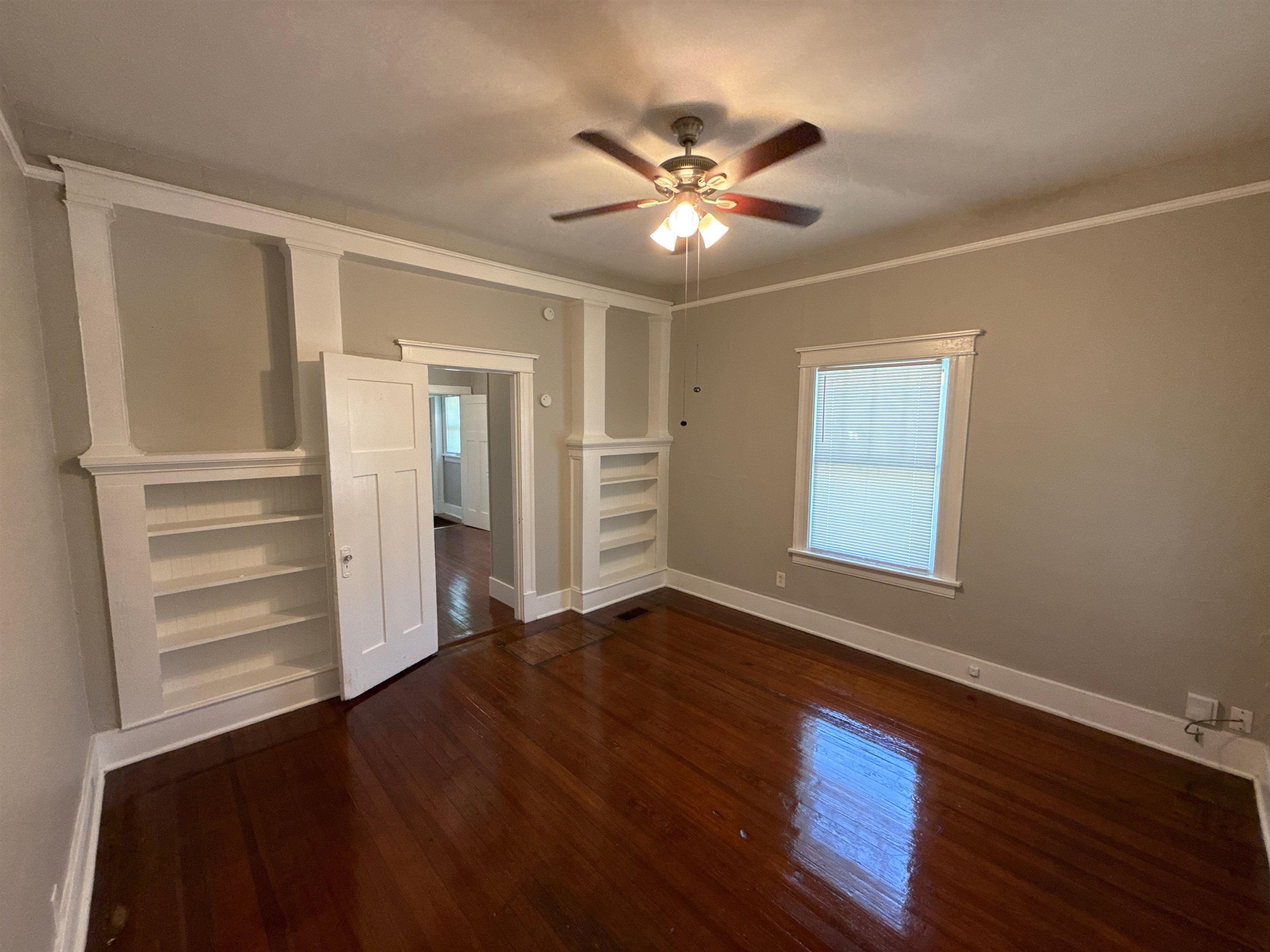1053 Fleece Place Memphis, TN 38104 - Photo 4 of 14 a view of an empty room with a window and wooden floor