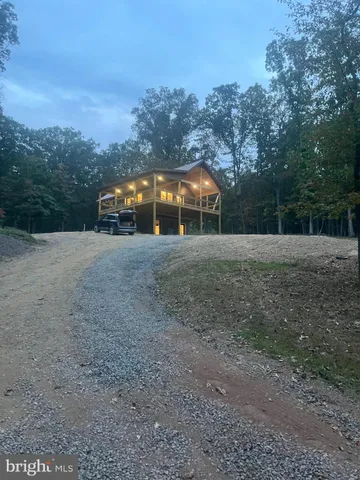 a view of large trees with a yard