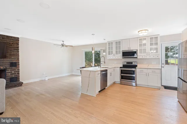 a kitchen with stainless steel appliances a refrigerator and stove top oven