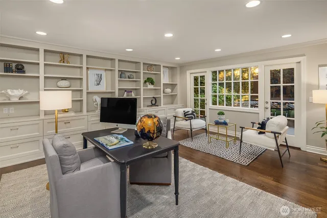 a living room with furniture a rug and a flat screen tv