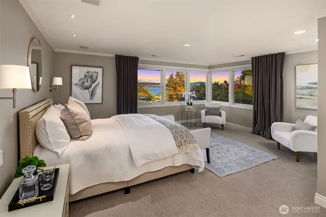 a large bedroom with a bed and glass walk in closet