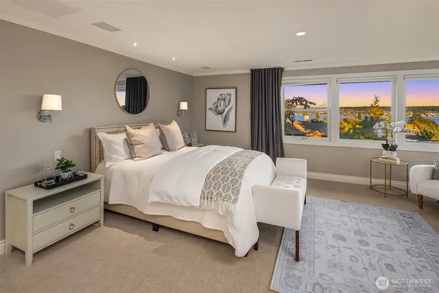 a bedroom with a large bed and a large window