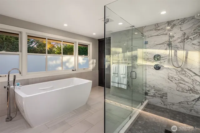 a bathroom with a bathtub and shower