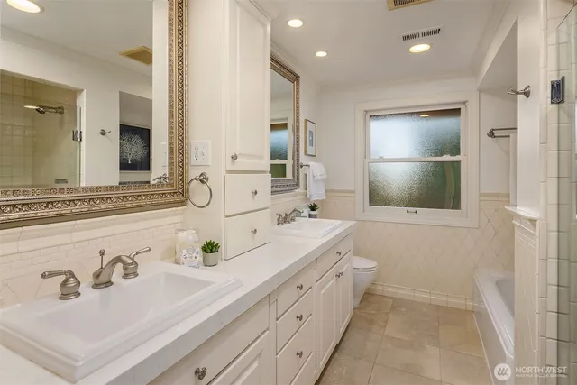 a bathroom with a double vanity sink mirror and double