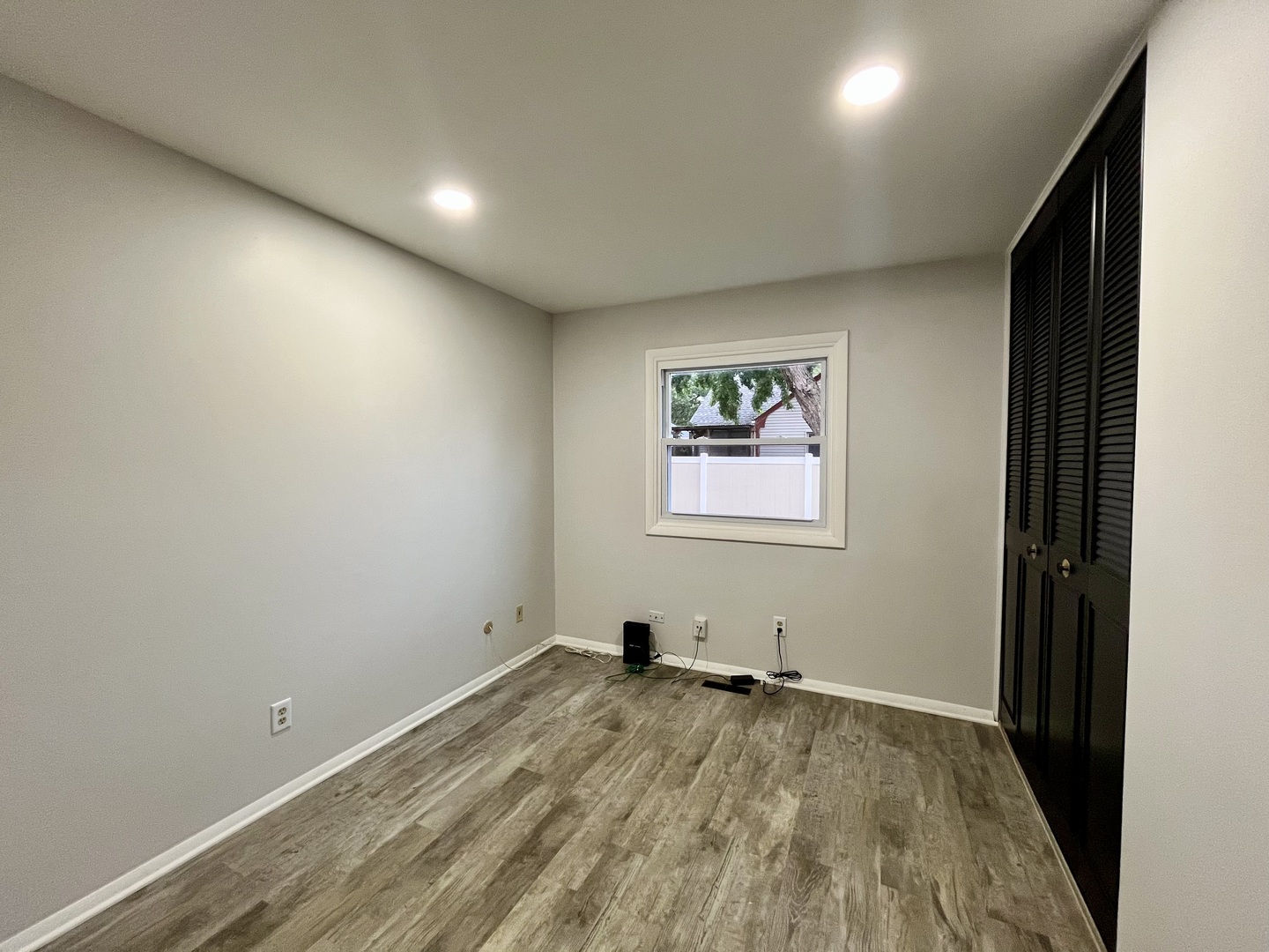 136 Heathgate Road Montgomery, IL 60538 - Photo 17 of 26 an empty room with wooden floor and windows