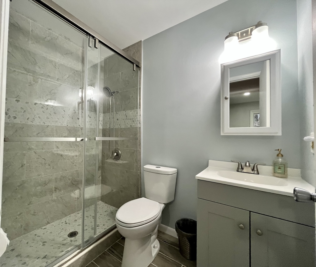 136 Heathgate Road Montgomery, IL 60538 - Photo 18 of 26 a bathroom with a shower a sink a toilet and mirror