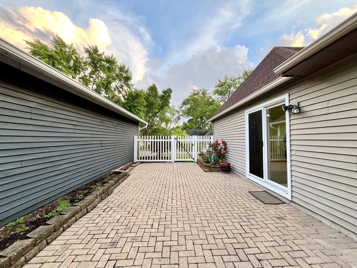 136 Heathgate Road Montgomery, IL 60538 - Photo 21 of 26 a view of a car with a small yard and wooden fence