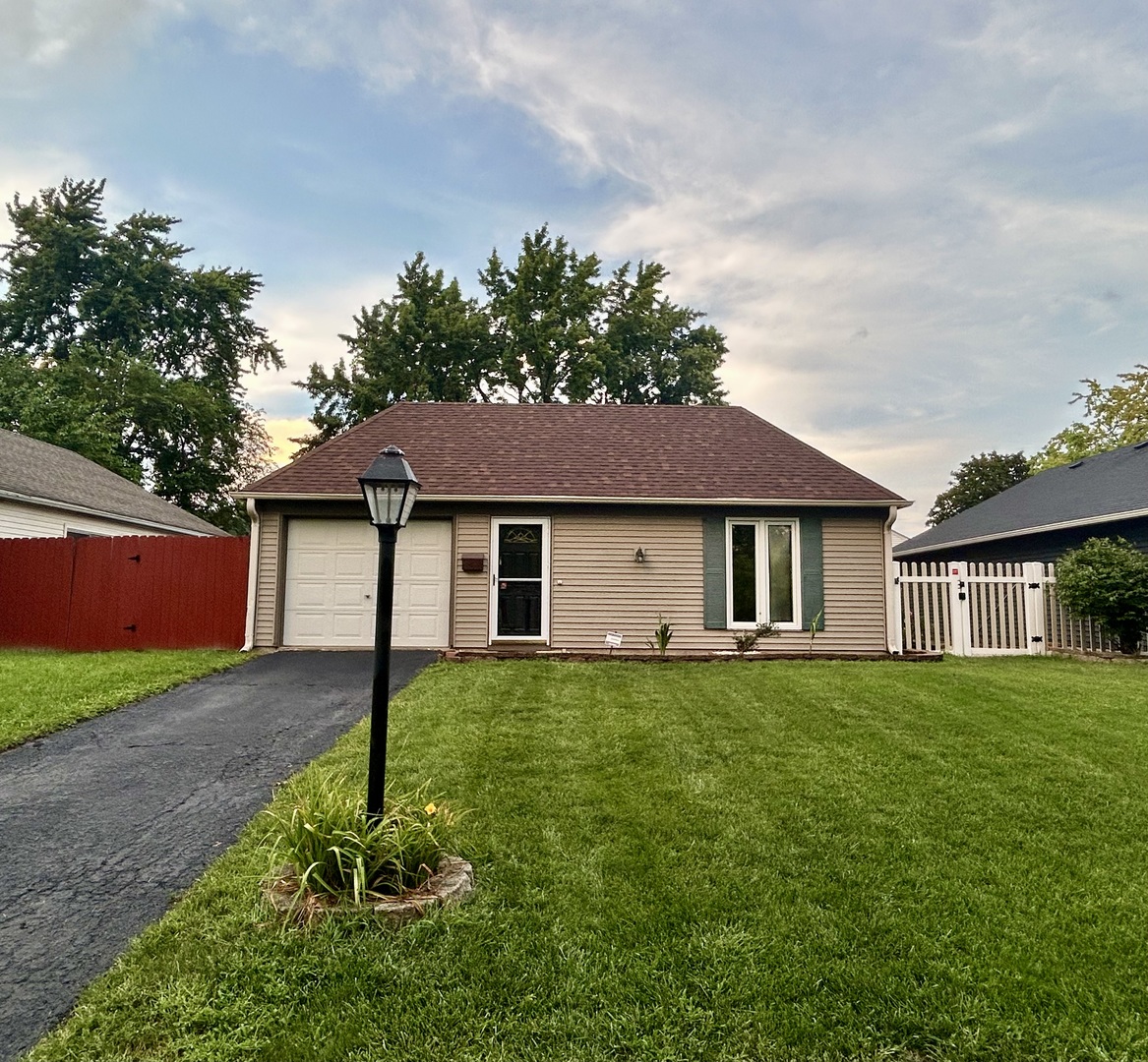136 Heathgate Road Montgomery, IL 60538 - Photo 3 of 26 a front view of a house with a yard and garage