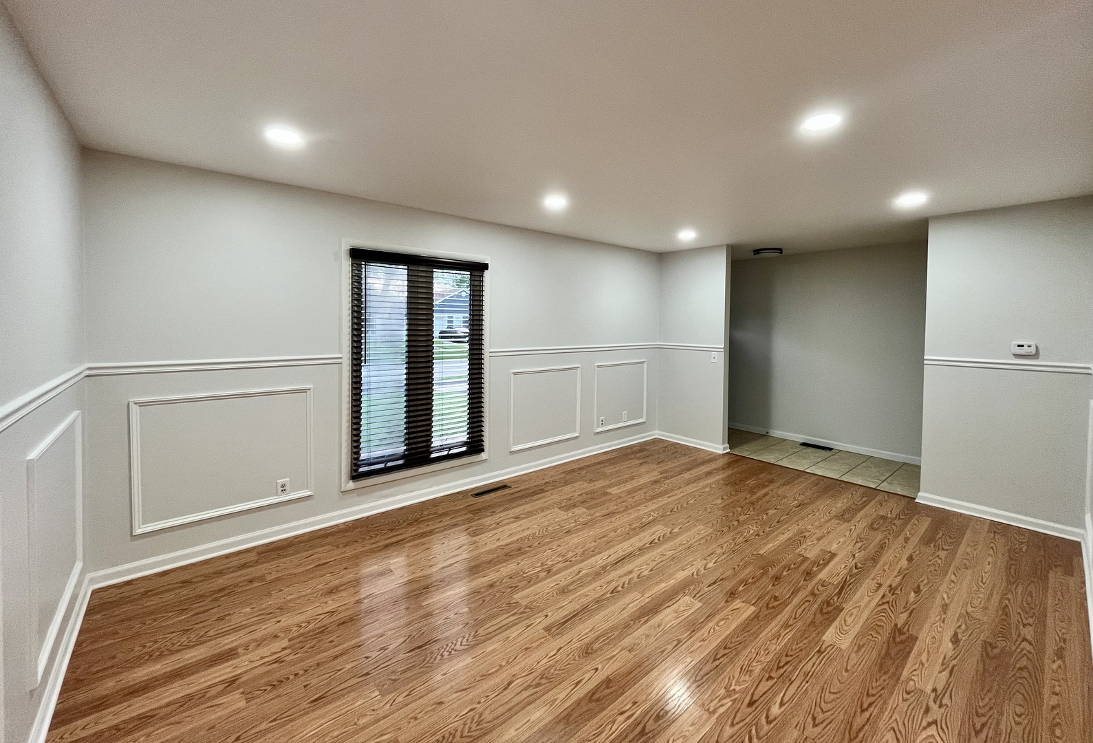 136 Heathgate Road Montgomery, IL 60538 - Photo 6 of 26 a view of an empty room with wooden floor and a window