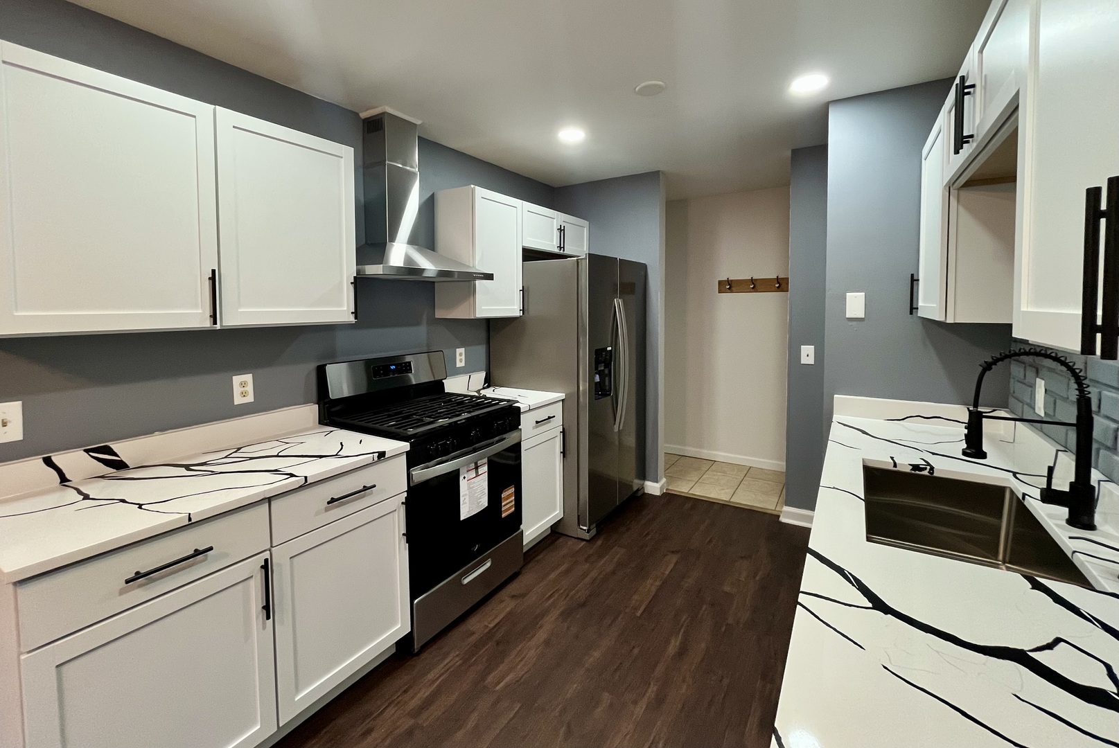 136 Heathgate Road Montgomery, IL 60538 - Photo 8 of 26 a kitchen with a stove cabinets and wooden floor