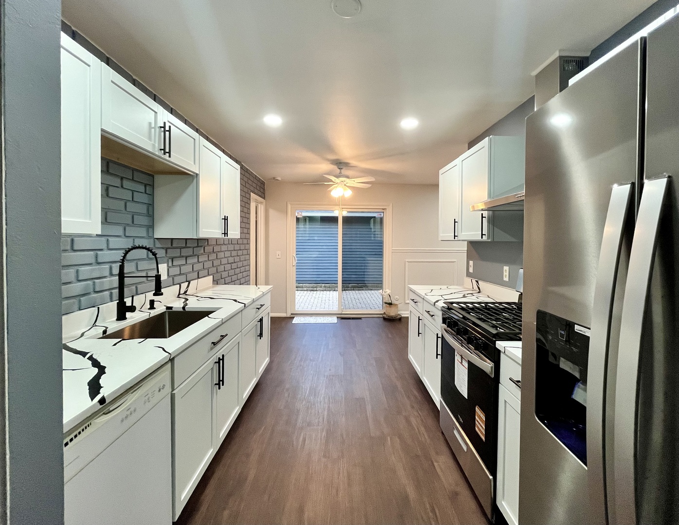 136 Heathgate Road Montgomery, IL 60538 - Photo 9 of 26 a kitchen with stainless steel appliances granite countertop a stove and a sink