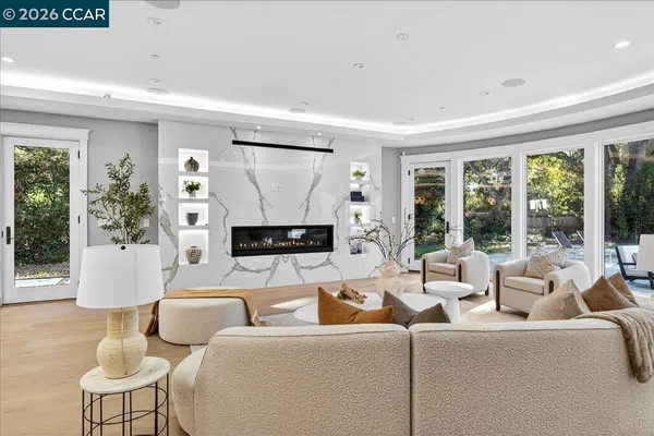 a living room with furniture a large window and a flat screen tv