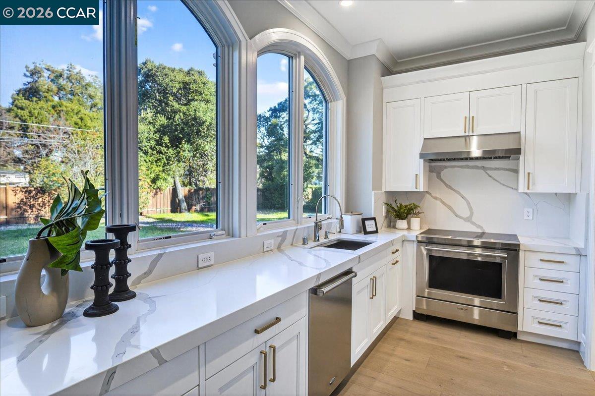 74 Middlefield Road Atherton, CA 94027 - Photo 16 of 49 a kitchen with a sink a stove and cabinets