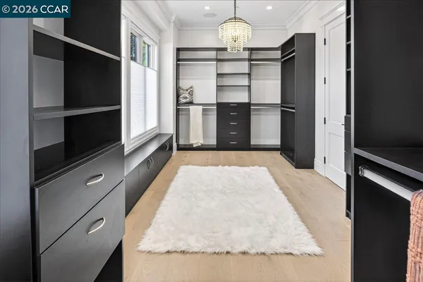 a kitchen with granite countertop stainless steel appliances and wooden floor