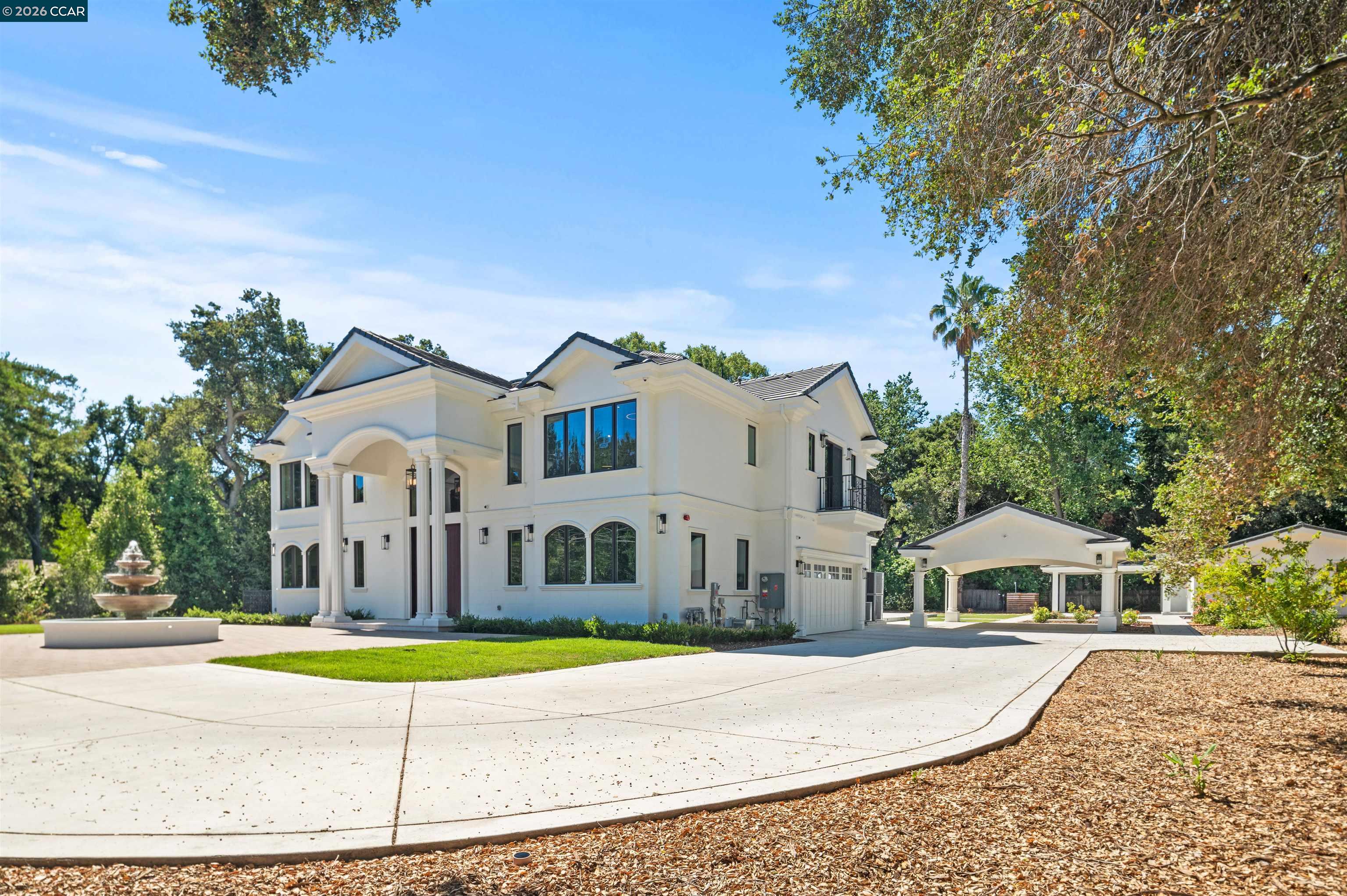 74 Middlefield Road Atherton, CA 94027 - Photo 48 of 49 a view of a white house with a large pool and large trees