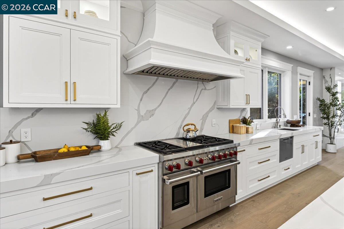 74 Middlefield Road Atherton, CA 94027 - Photo 6 of 49 a kitchen with stainless steel appliances white cabinets and white stove