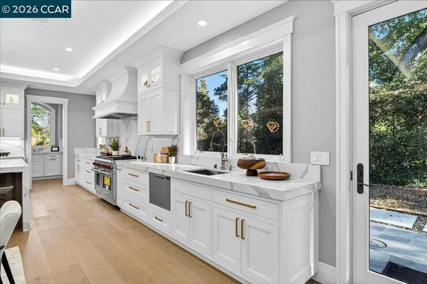 a kitchen with stainless steel appliances granite countertop a stove and a sink