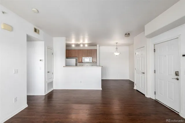 a view of a kitchen and an empty room