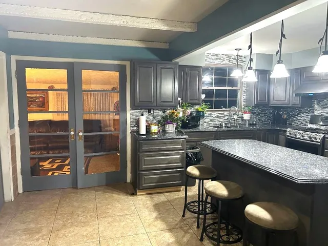 a kitchen with a table and chairs