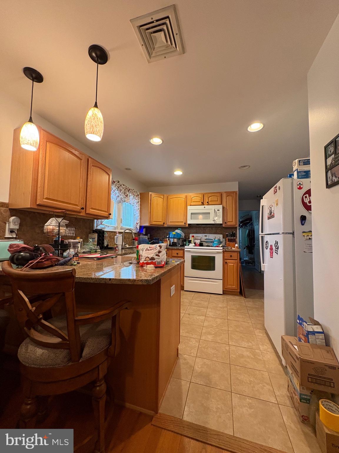148 Amwellbury Road Salem, NJ 08079 - Photo 16 of 24 a kitchen with refrigerator and chairs