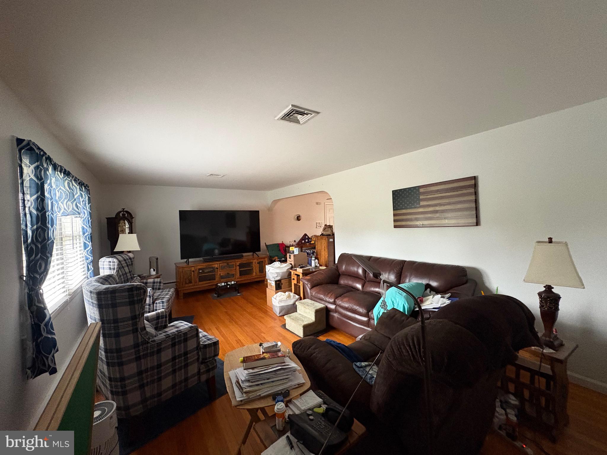 148 Amwellbury Road Salem, NJ 08079 - Photo 17 of 24 a living room with furniture and a flat screen tv