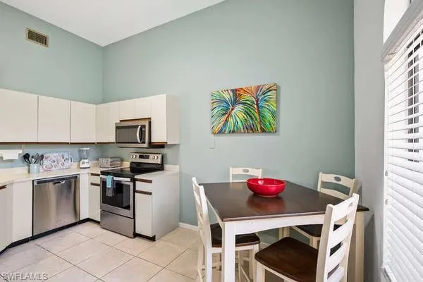 a kitchen with stainless steel appliances a stove a sink and a refrigerator