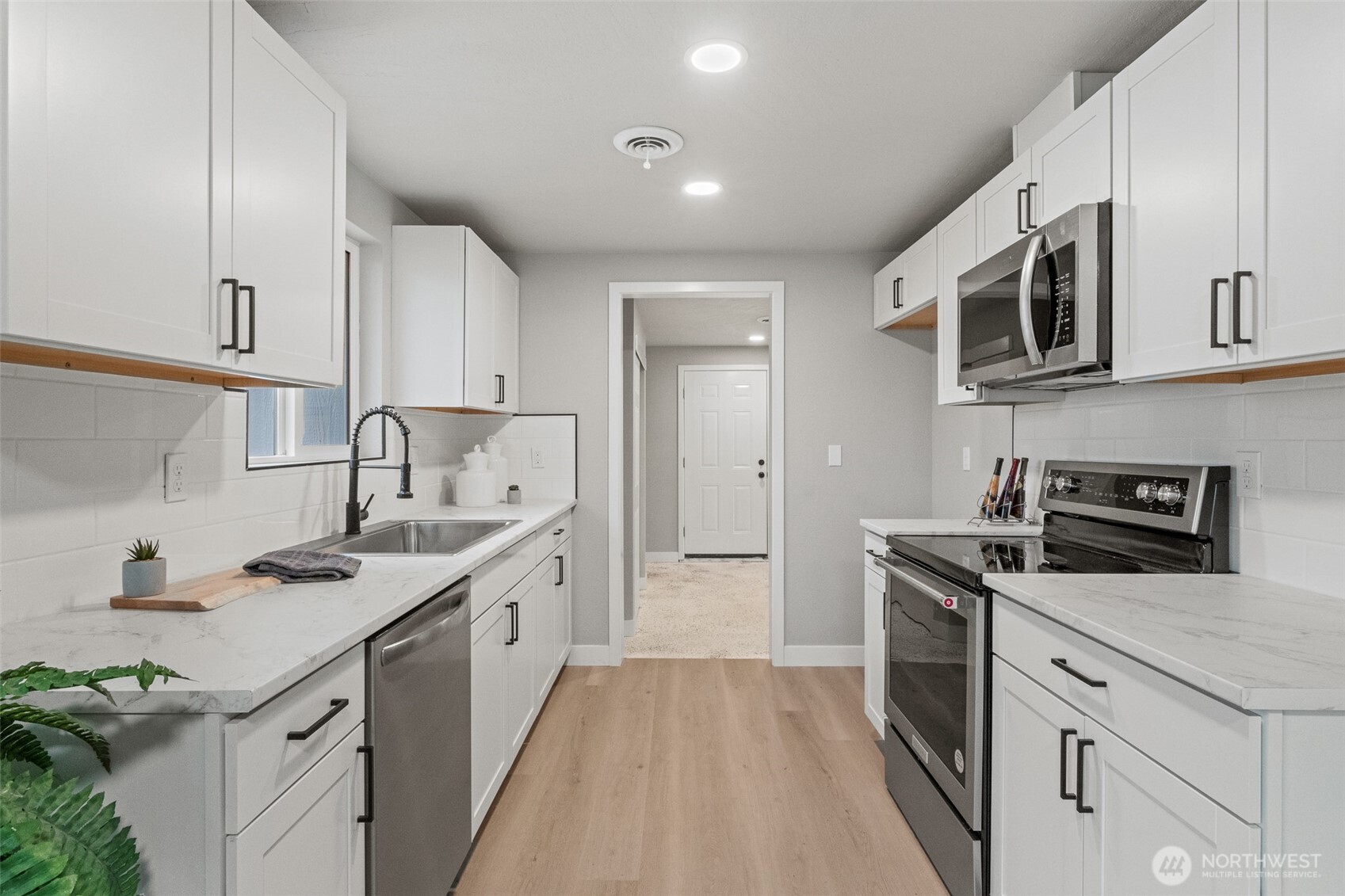 307 3rd Avenue Northeast Quincy, WA 98848 - Photo 7 of 26 a kitchen with stainless steel appliances granite countertop a sink stove oven and refrigerator