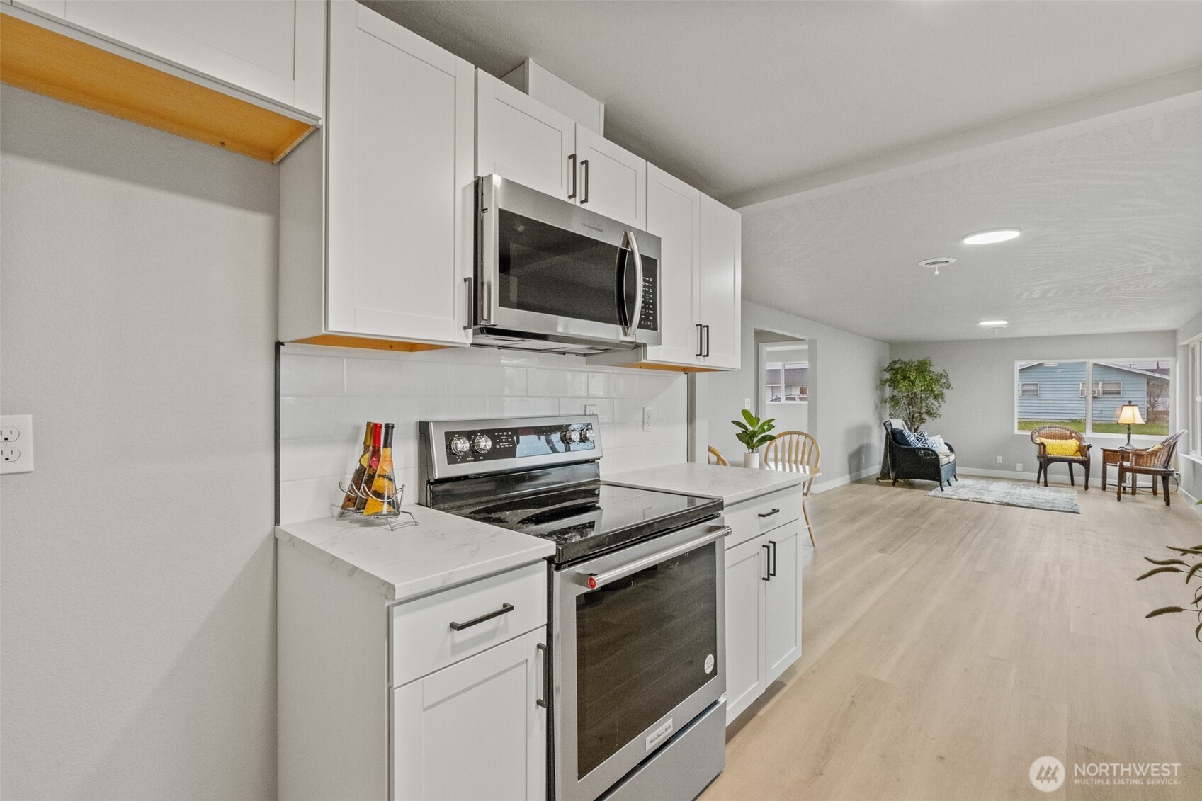 307 3rd Avenue Northeast Quincy, WA 98848 - Photo 10 of 26 a kitchen with stainless steel appliances a stove microwave and cabinets