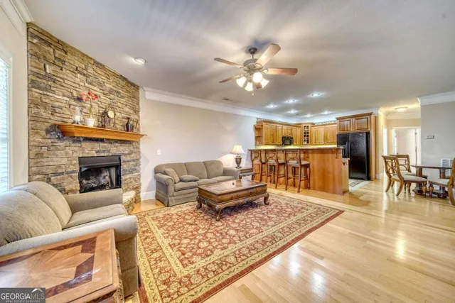 a living room with furniture and kitchen view